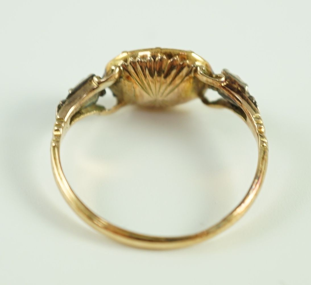 A George III gold, foil backed garnet and rose cut diamond set three stone ring